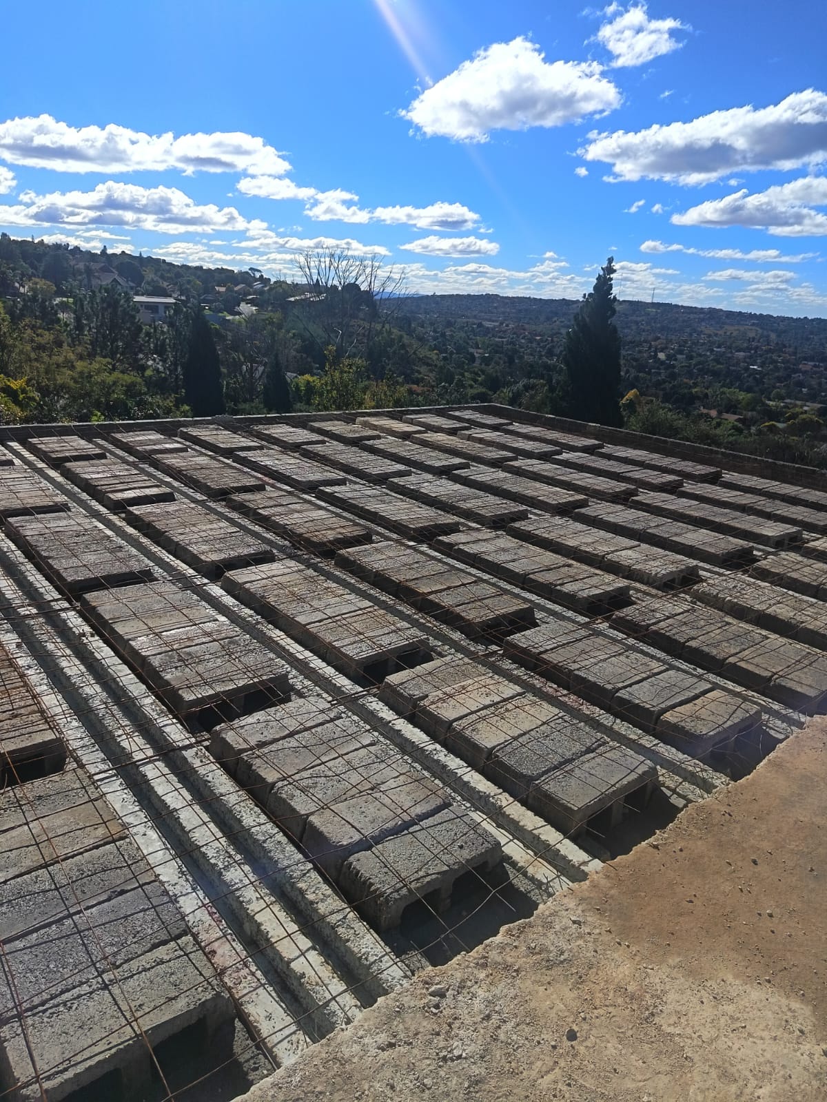 Aerial view of hollow core rib and block slab installation with Johannesburg skyline in background