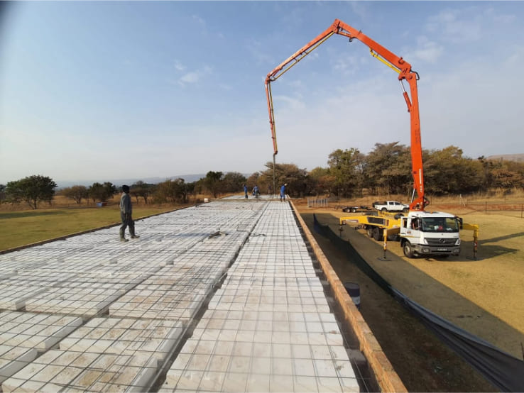 Large-scale polystyrene rib and block slab installation with concrete pump truck, Gauteng