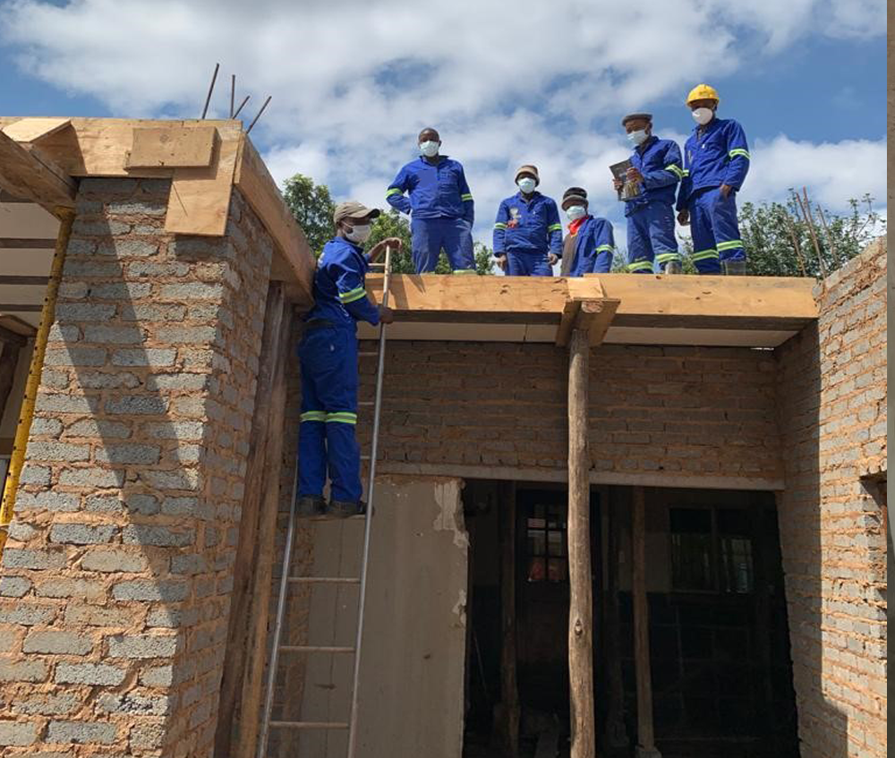 Slab2Slab construction crew building a brick wall and timber roof structure