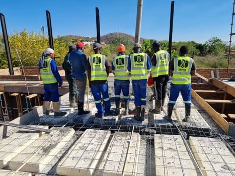 Slab2Slab team in branded vests on a rib and block slab installation site